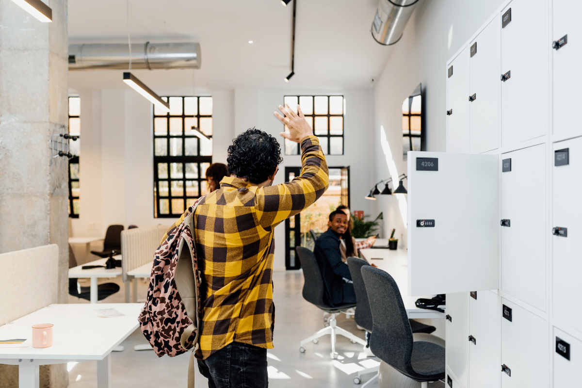Un travailleur qui dit au revoir à ses collègues dans un flex office